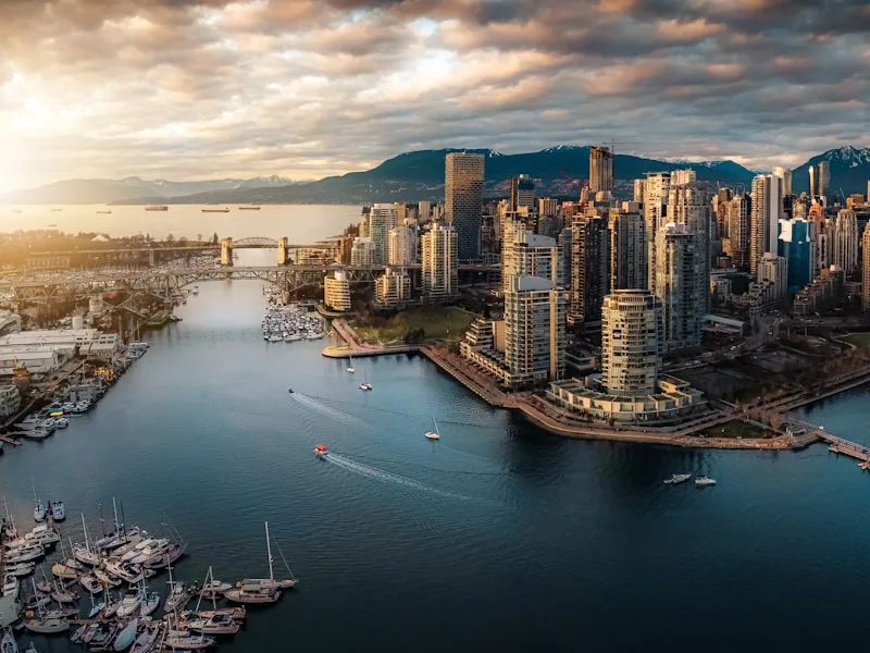 Coal Harbour waterfront condo towers along the seawall with North Shore mountain views