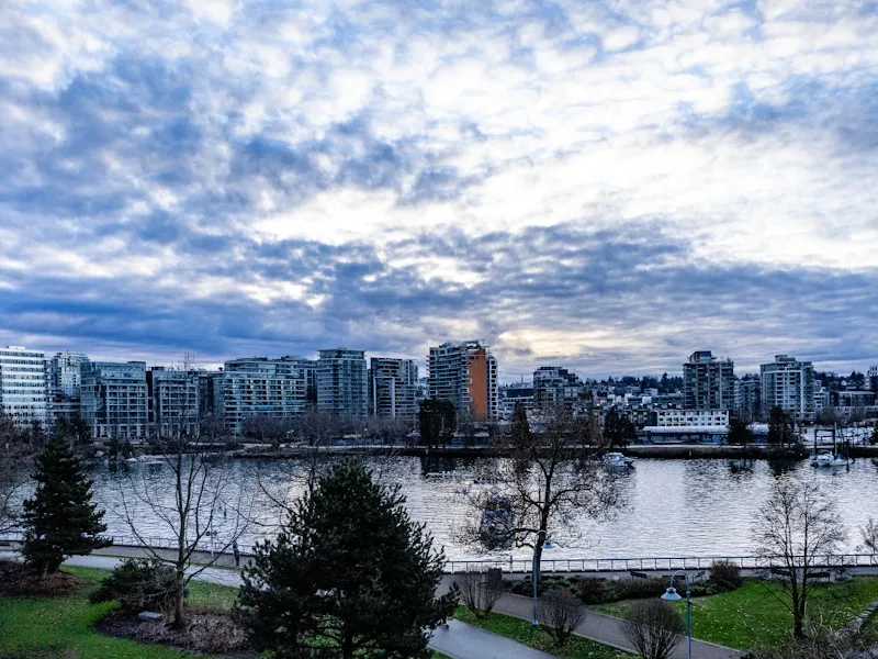 Modern waterfront condos and city skyline at Olympic Village Vancouver