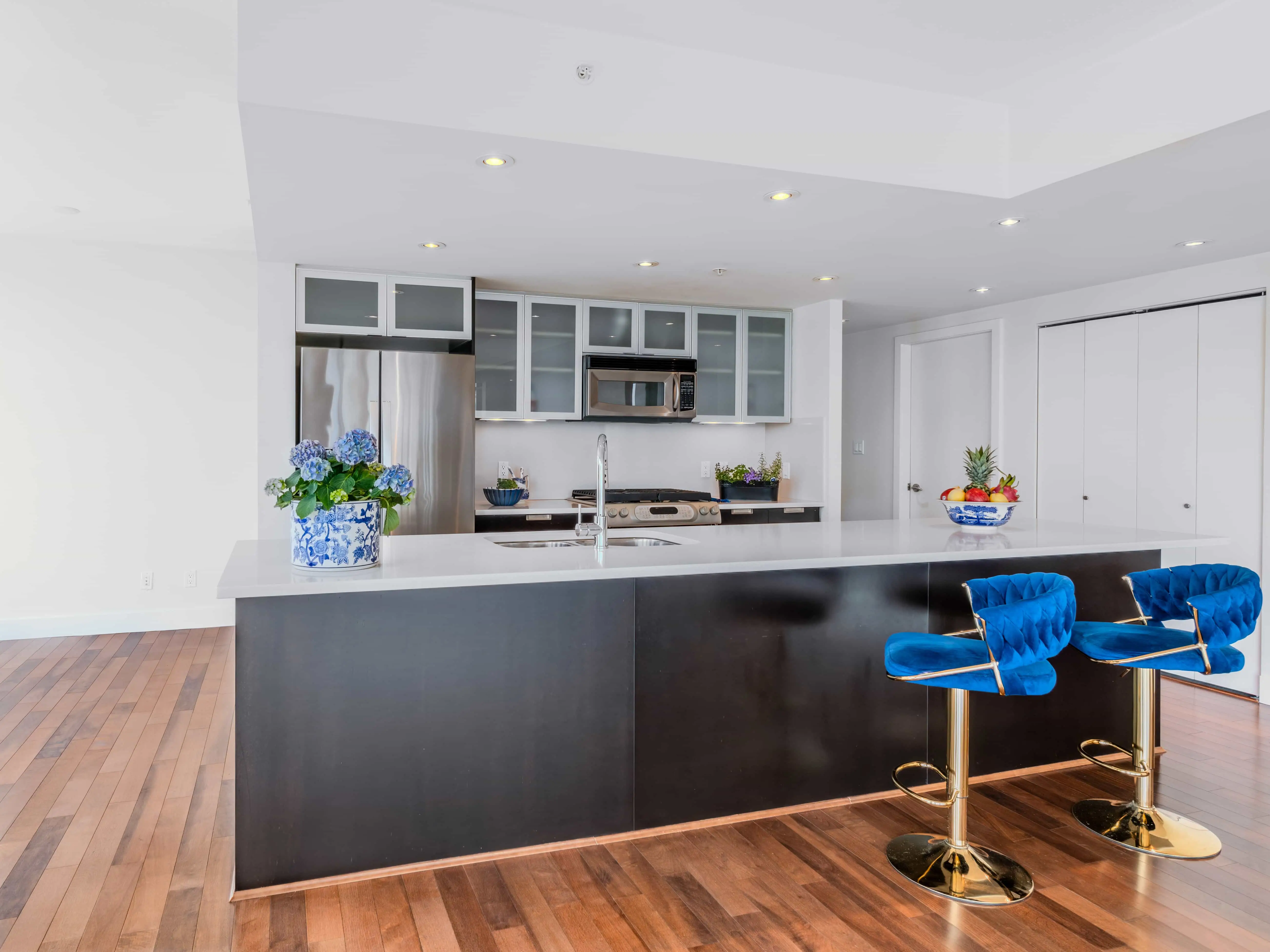 Coal Harbour condo kitchen with island and bar seating, Vancouver real estate photography