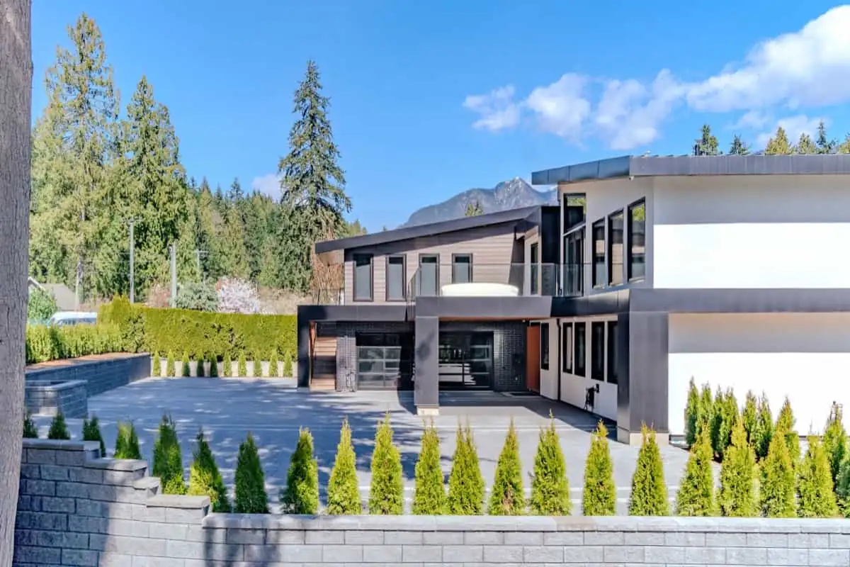 Modern Vancouver home exterior with cedar facade and mountain backdrop, real estate photography